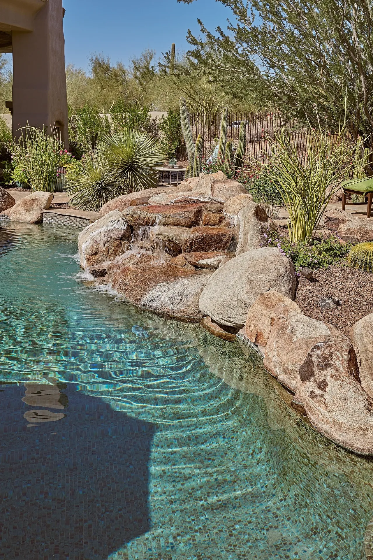 A pool with water running down the side of it.