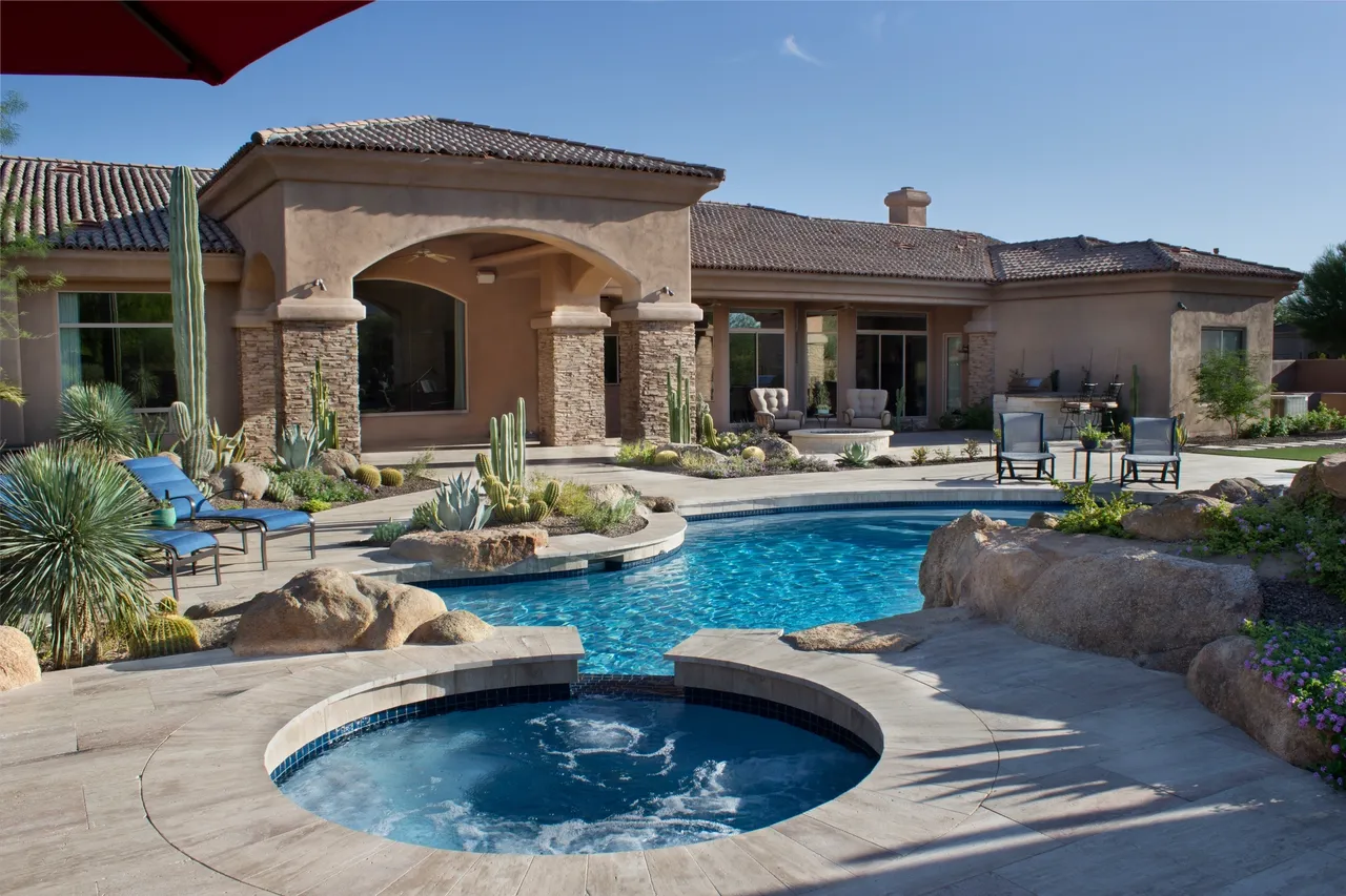 A pool with a hot tub in the middle of it