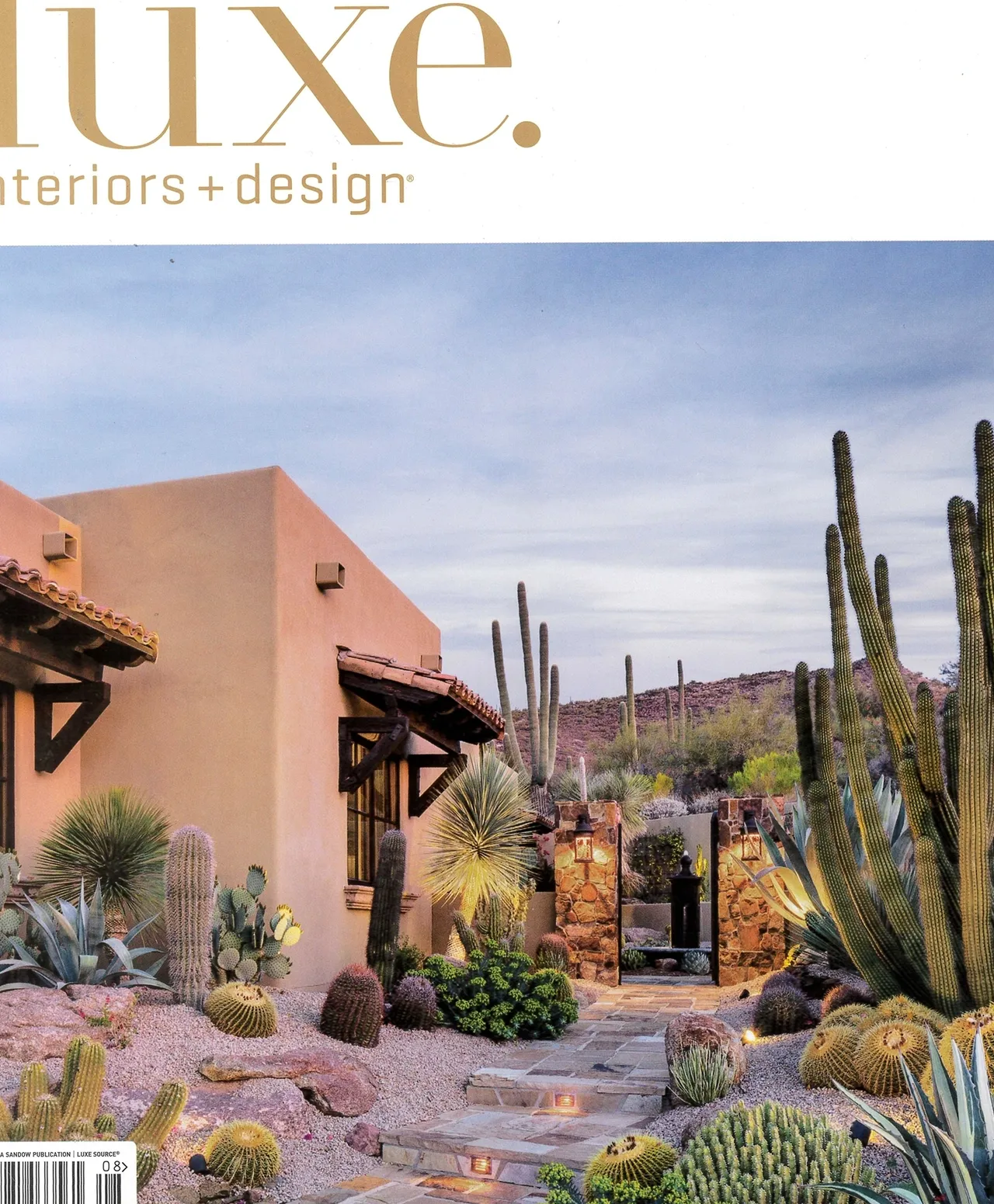 A desert landscape with cacti and shrubs.