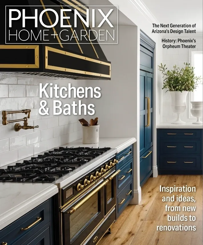 A kitchen with blue cabinets and black appliances.