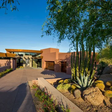 A large driveway with a house and some trees