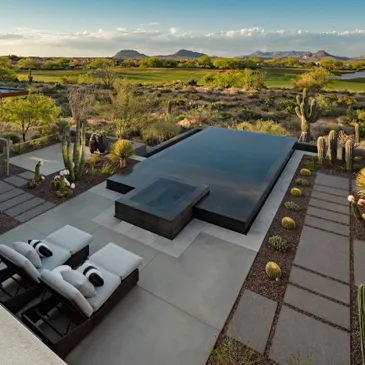 A large pool with a view of the desert.