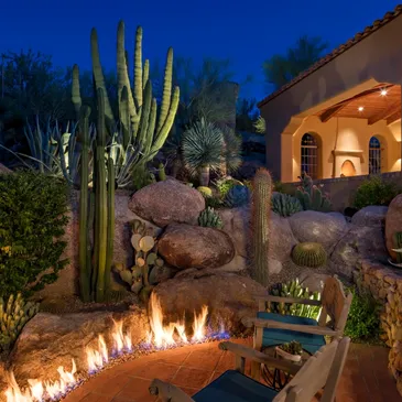 A fire pit in the middle of a garden.