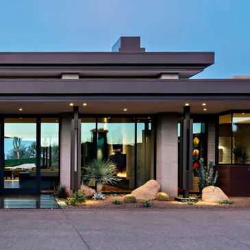 A building with a large window and some rocks