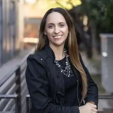 A woman standing on top of a metal railing.