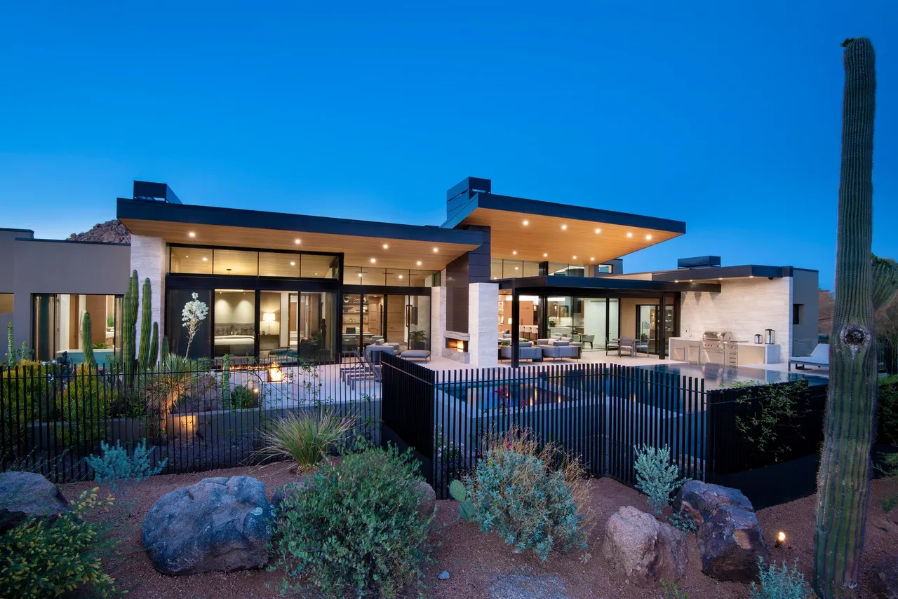 A large modern house with a patio and garden.