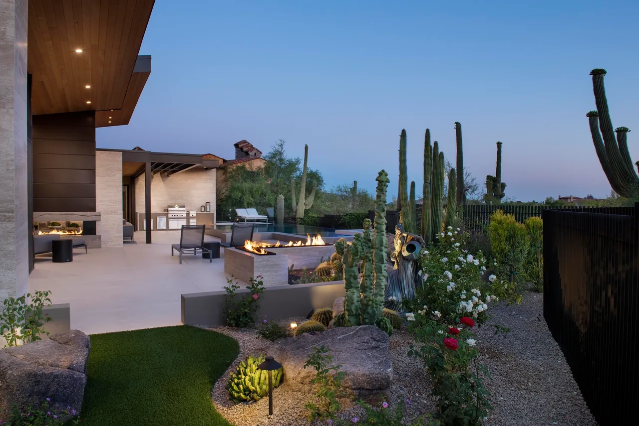 A patio with flowers and cactus in the middle of it.