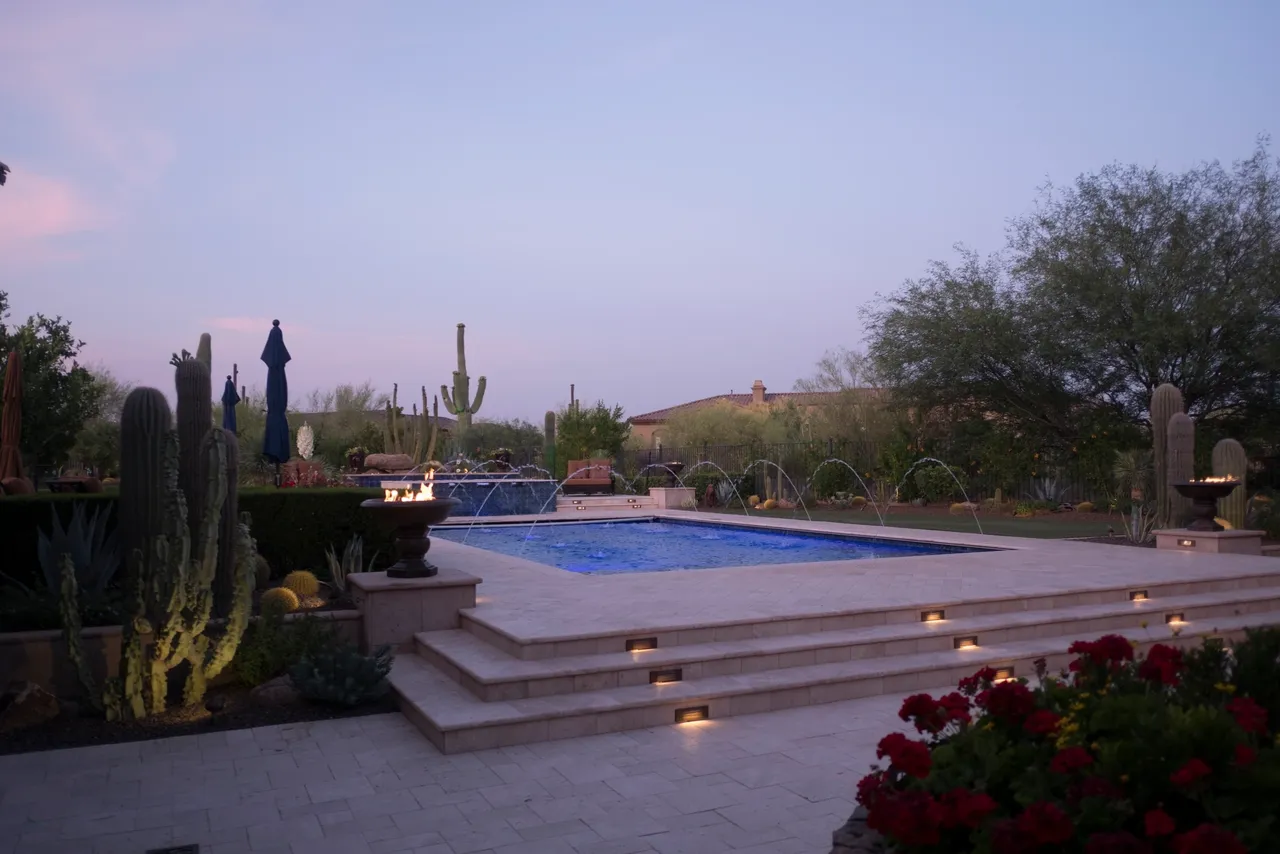 A pool with steps leading to the top of it.