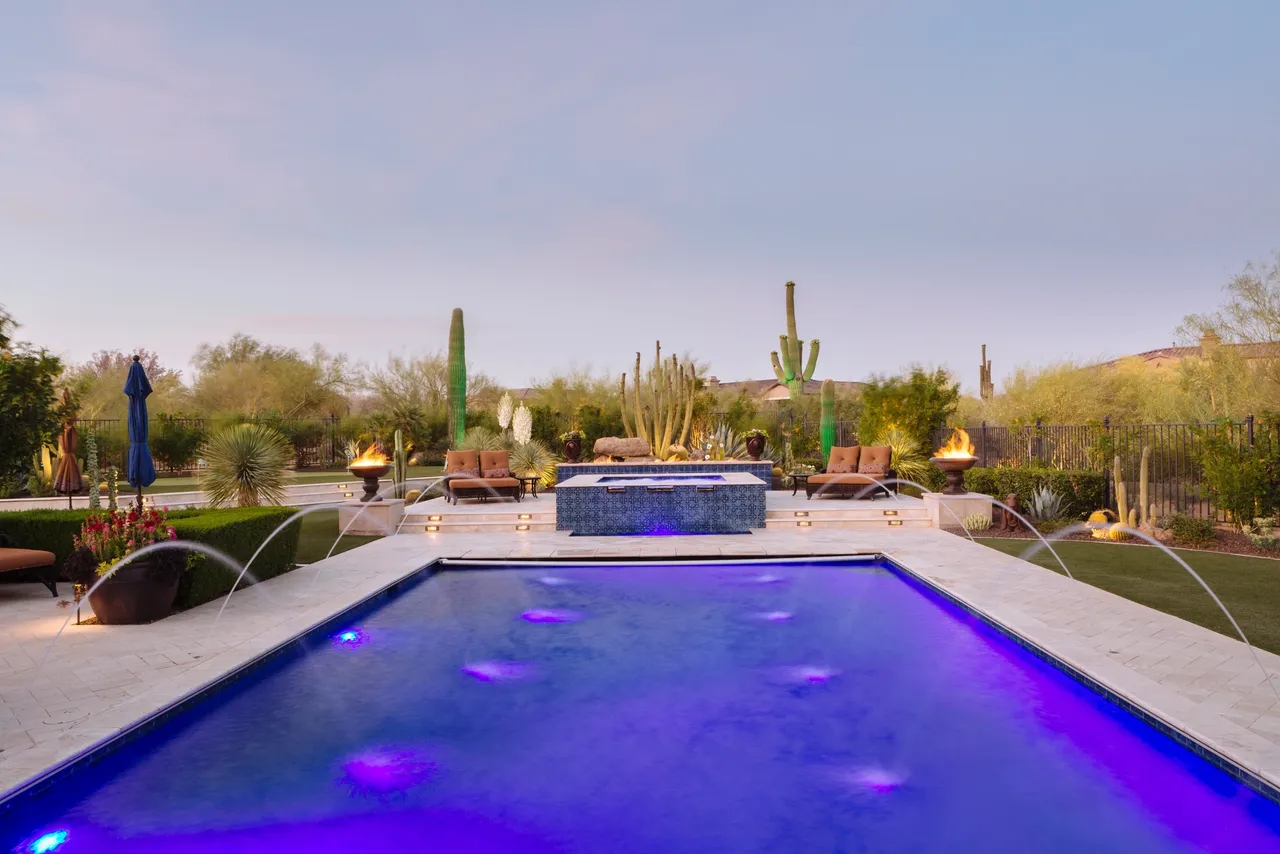 A pool with purple water and many cactus