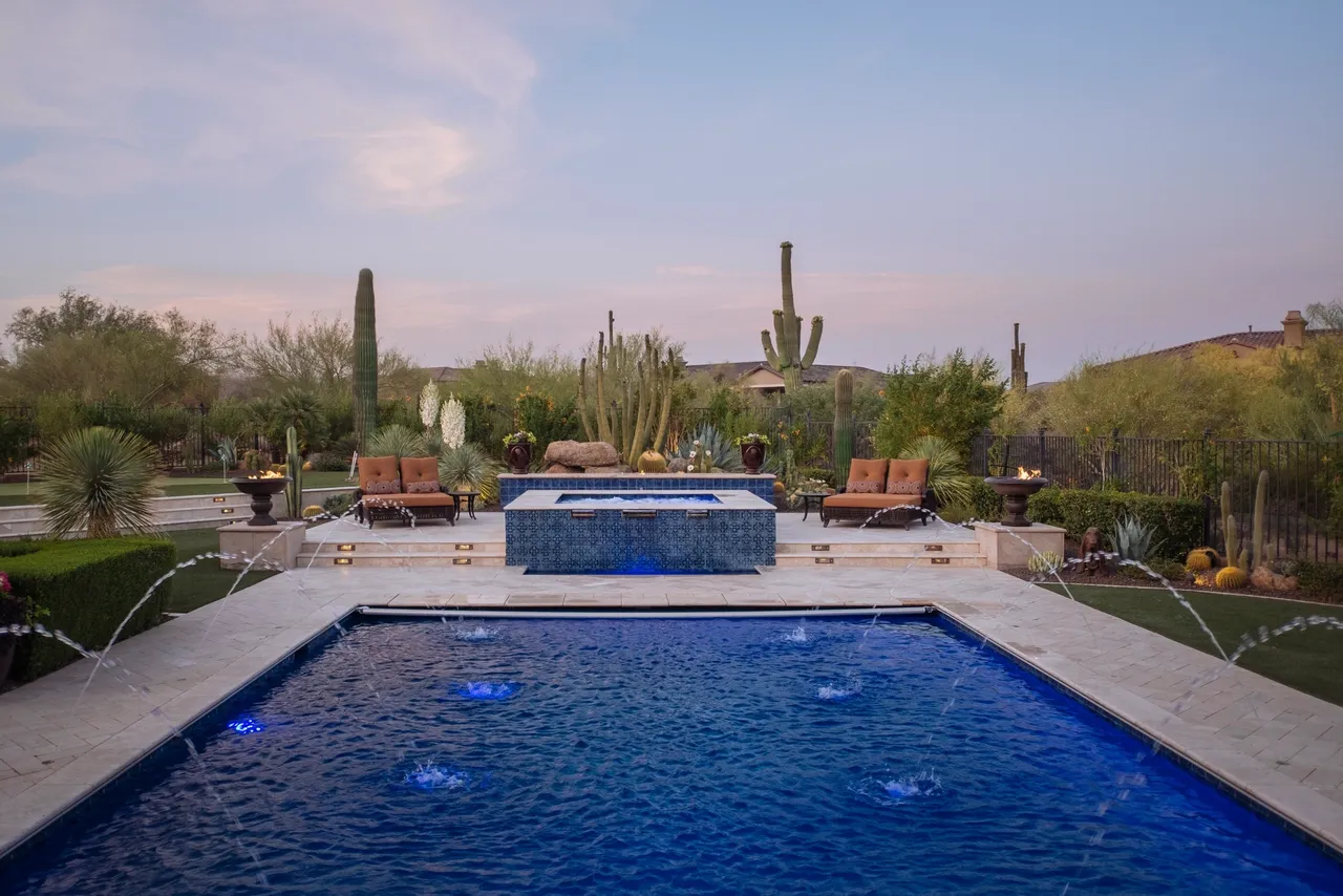 A pool with a hot tub in the middle of it