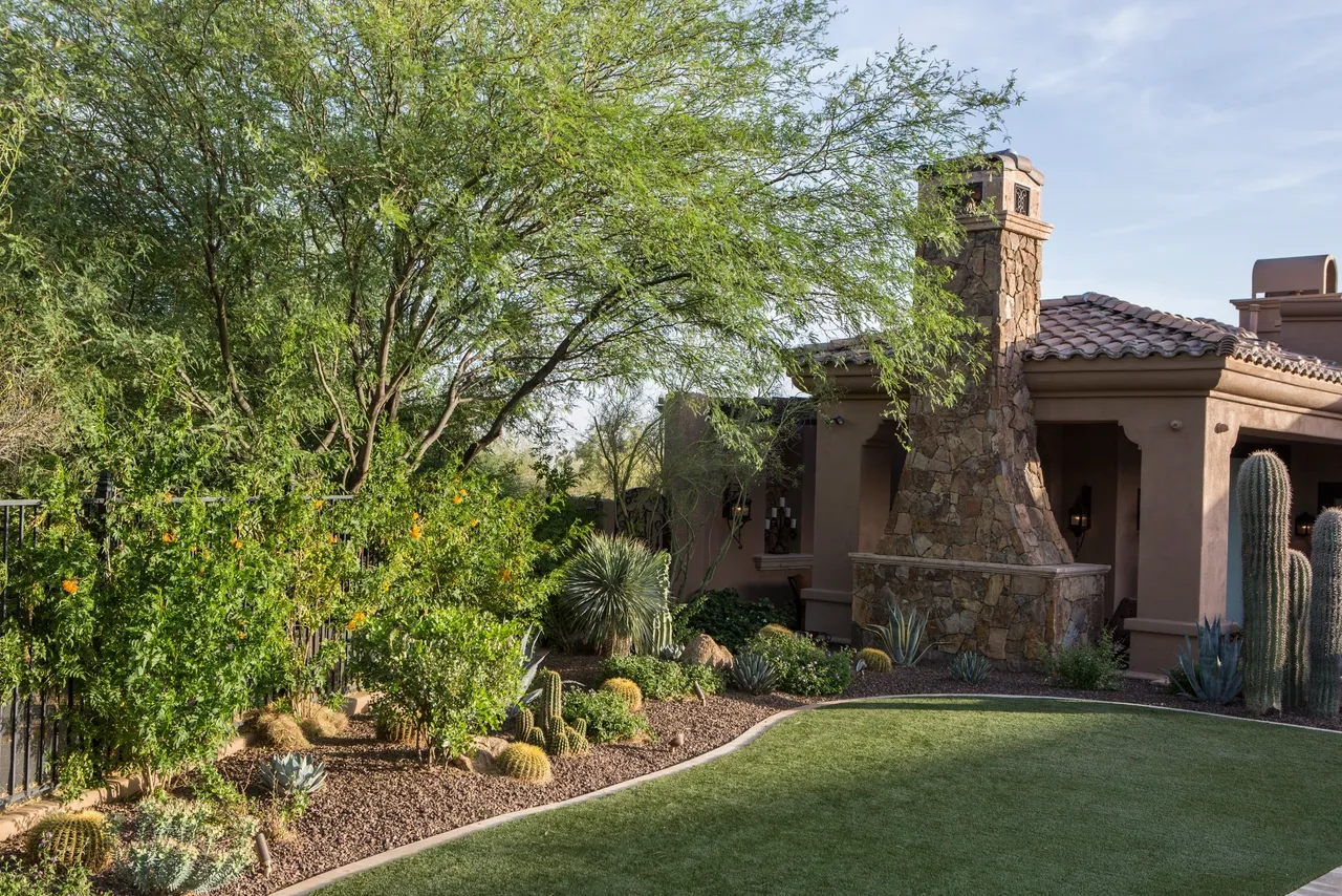 A house with a garden and trees in the background