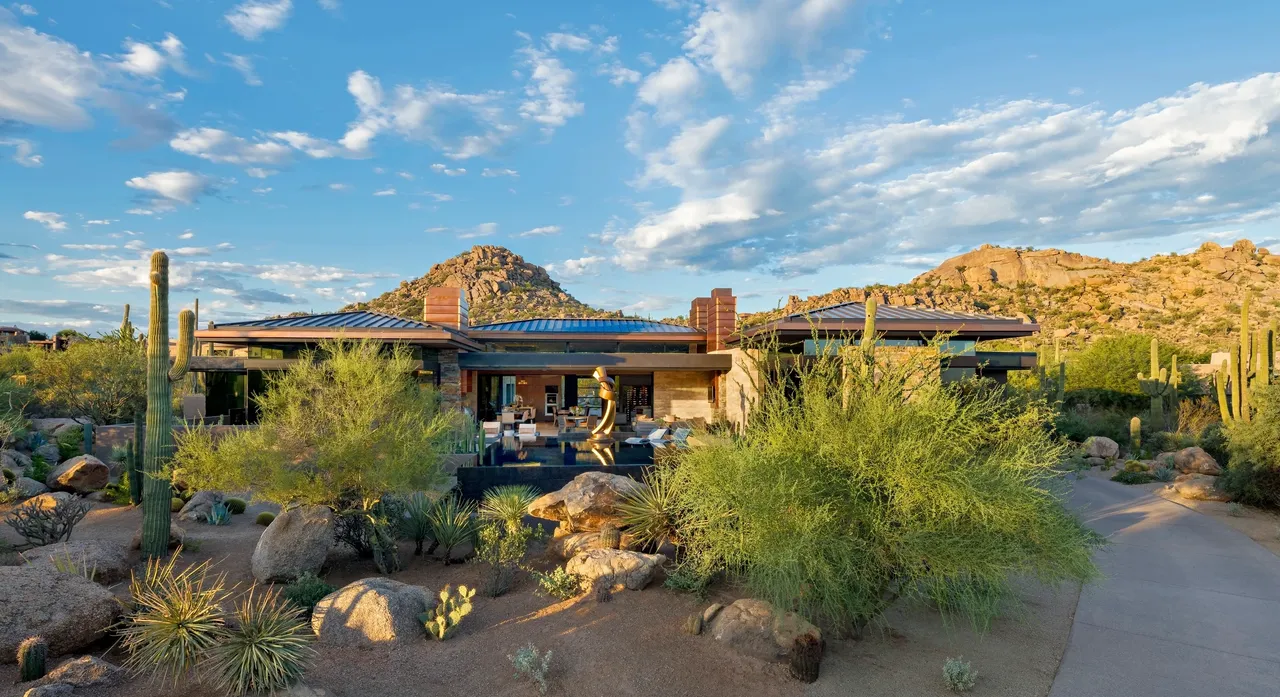 A house with a large patio and a mountain view.