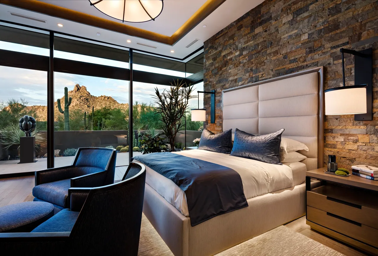 A bedroom with a large bed and a view of the mountains.