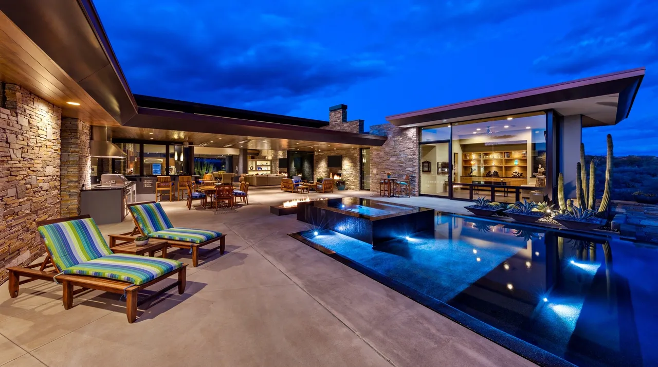 A pool with chairs and a table in the middle of it