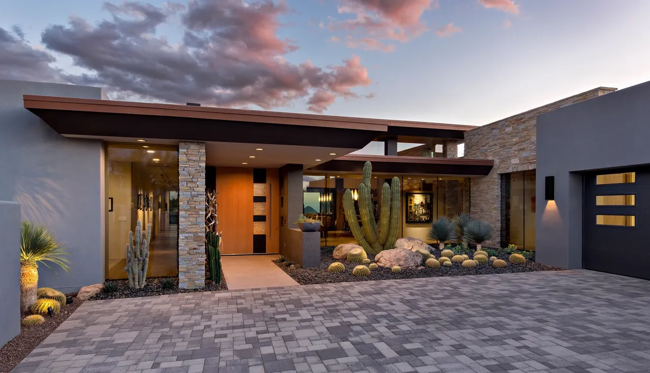 A modern home with cactus and stone accents.