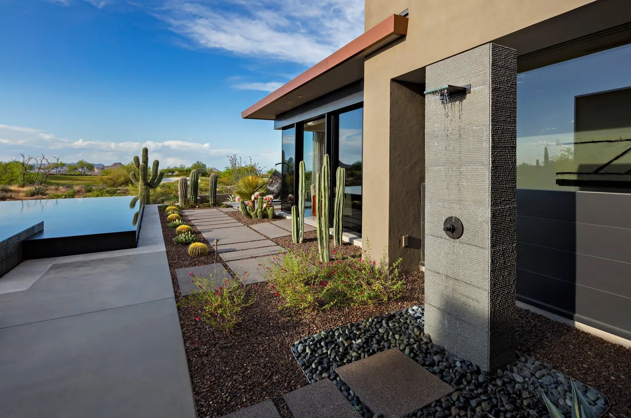 A patio with a pool and a desert landscape.