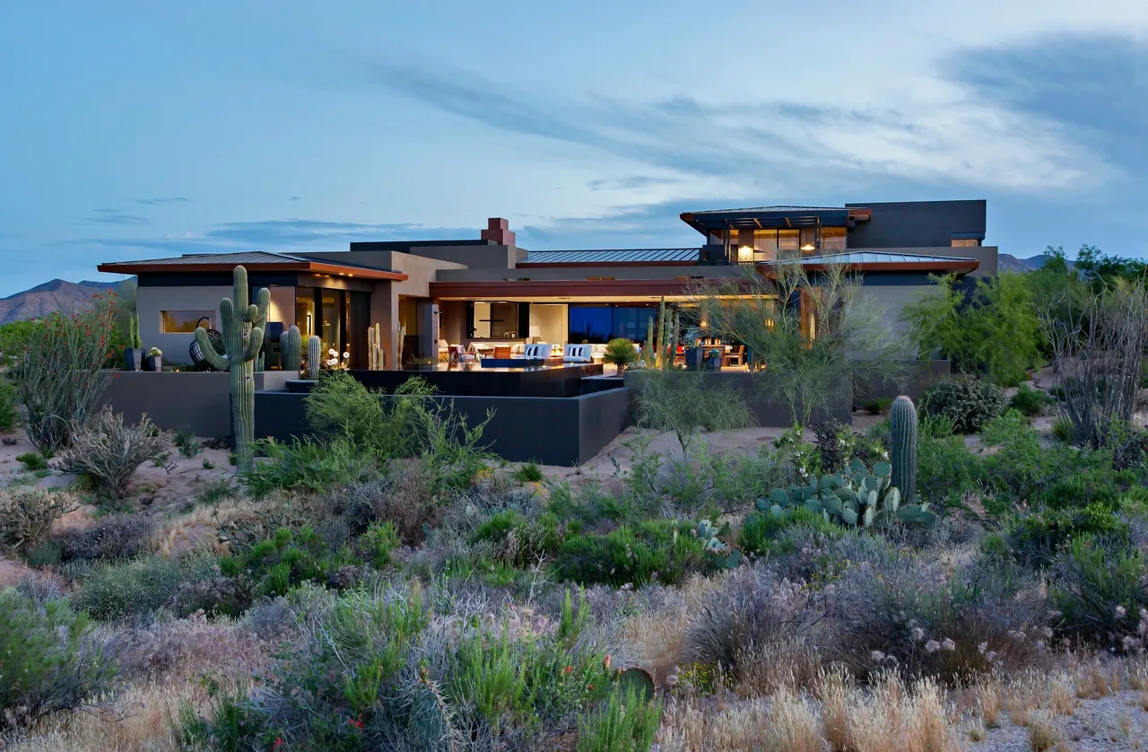 A large house with a lot of plants in the yard