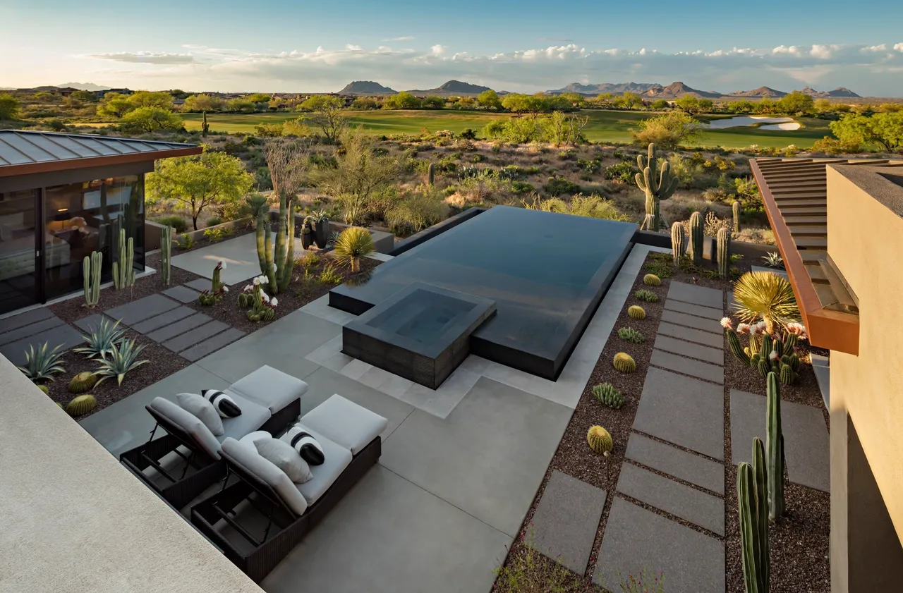 A large pool with a view of the desert.