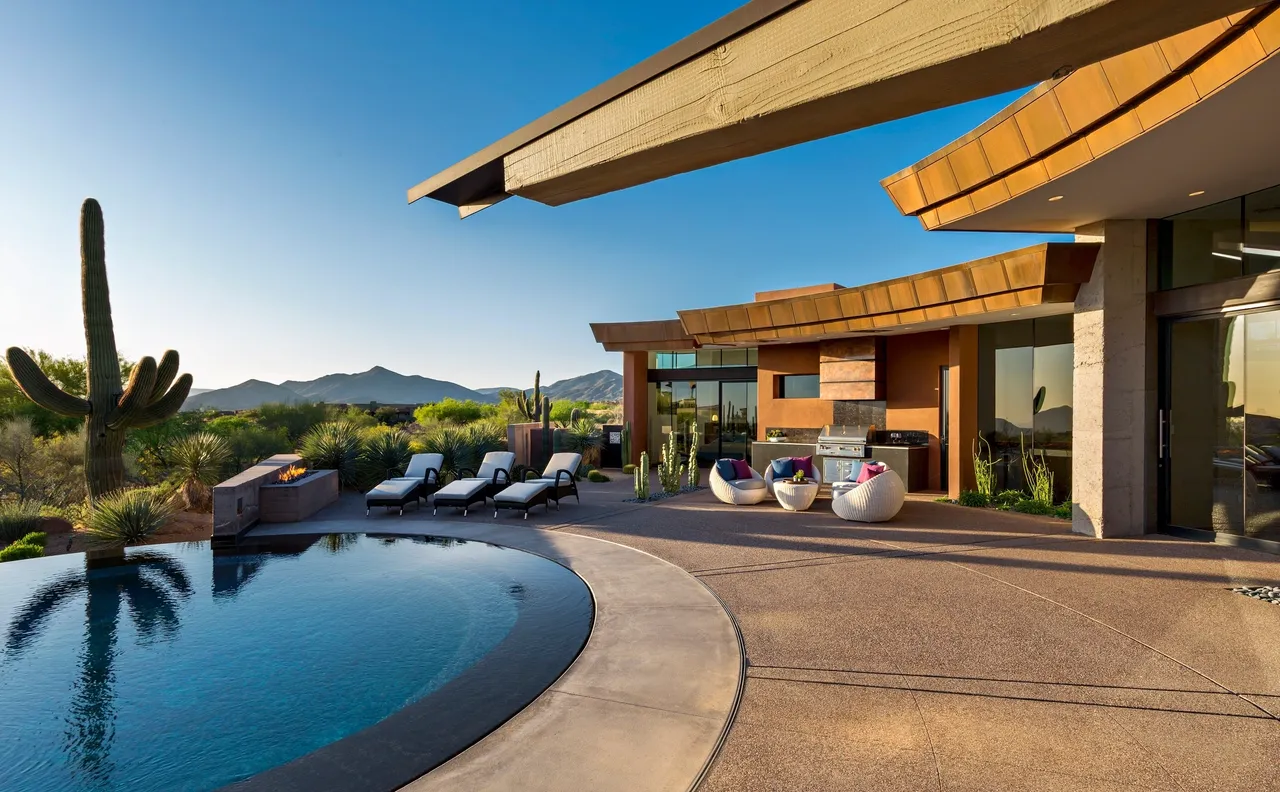 A pool with chairs and a roof over it