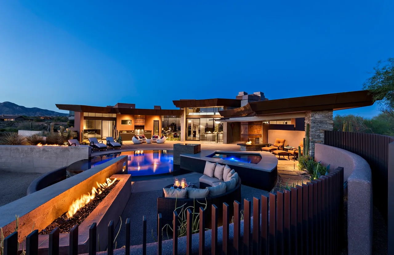 A large backyard with pool and fire pit.