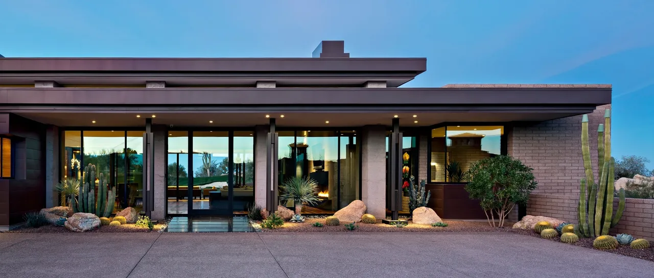 A large building with a lot of windows and rocks