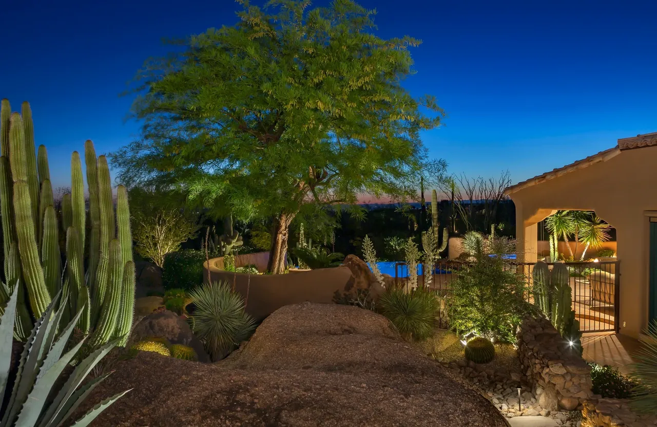 A large tree in the middle of a garden.