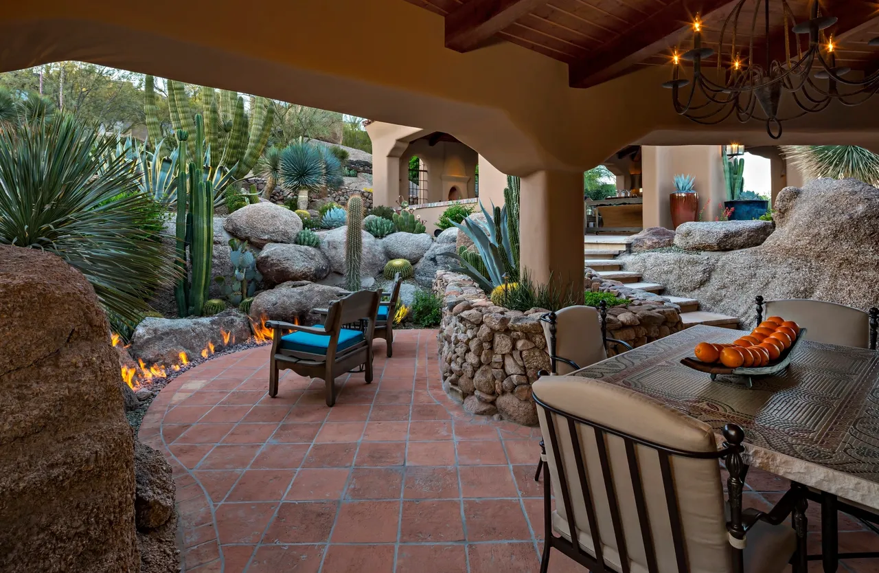 A patio with chairs and tables in the middle of it