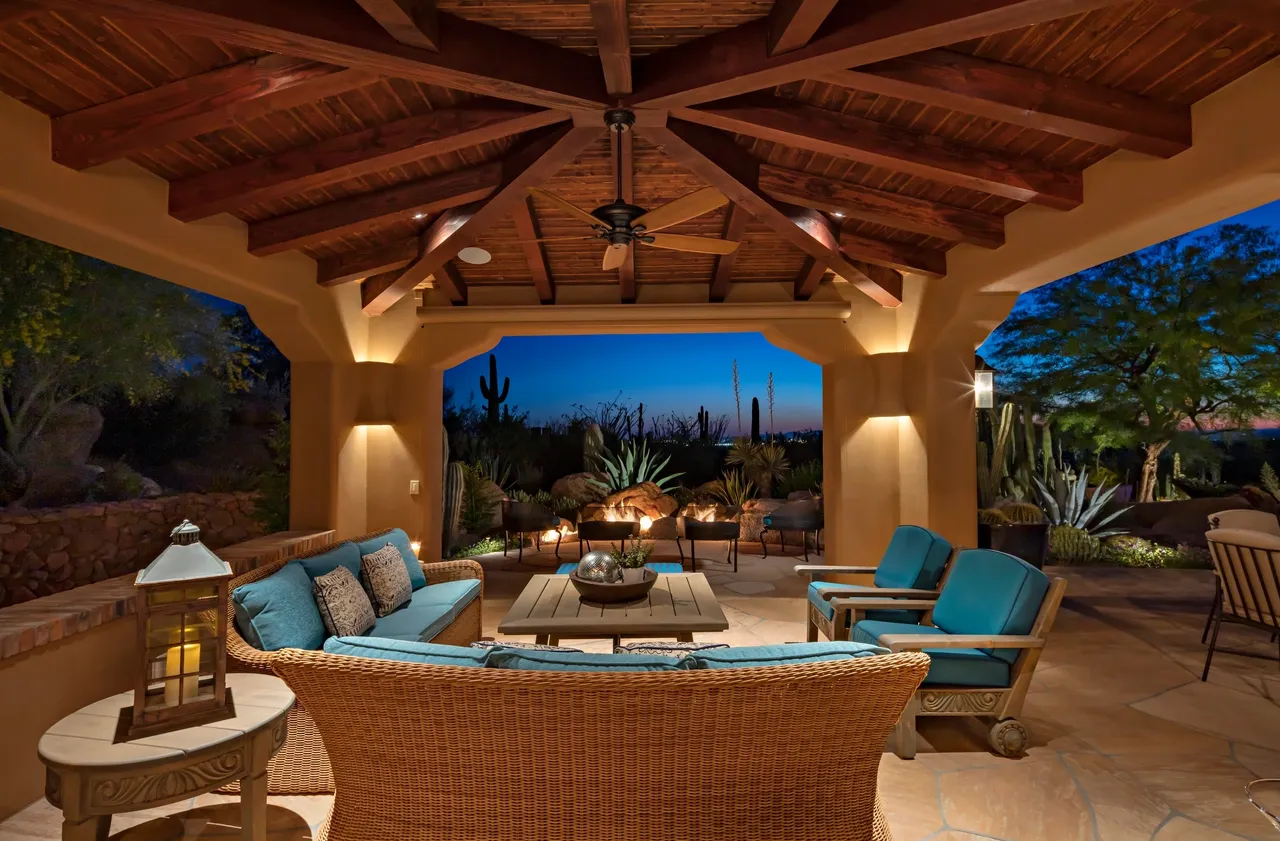 A patio with couches and tables in the middle of it